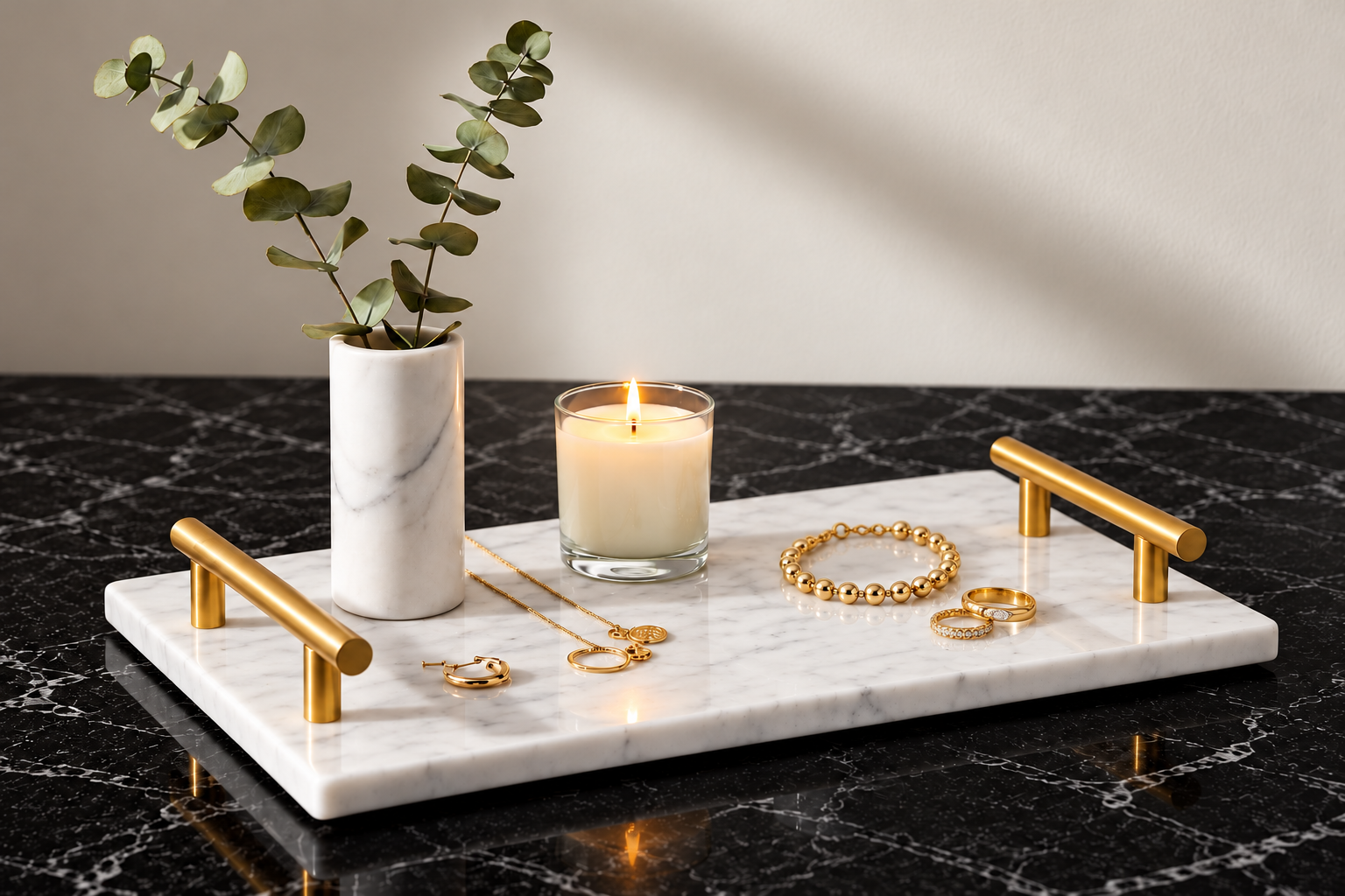 White marble toiletry stand with gold handles, jewelry, a candle, and a vase